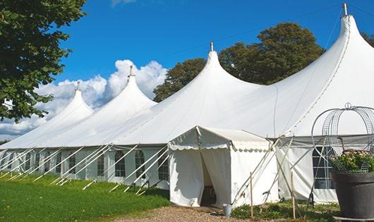 a group of luxury portable restrooms with individual stalls and running water in Garrison